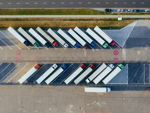 Aerial view of trucks parked in rows at a logistics yard